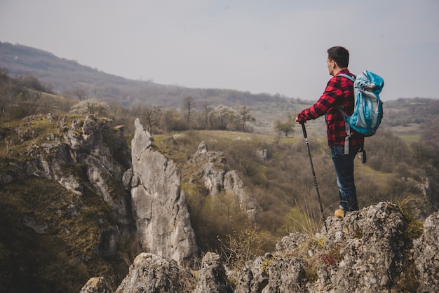 Free photo side view of rambler with backpack enjoying nature