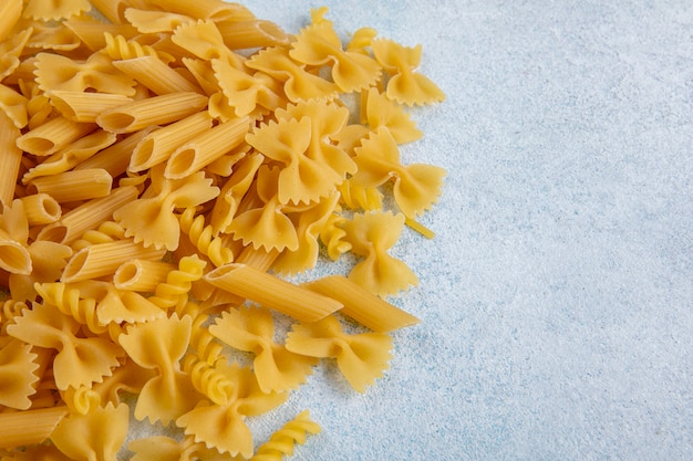 Side view of raw pasta on a gray surface