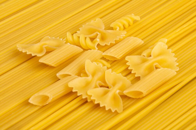 Side view of raw spaghetti with pasta