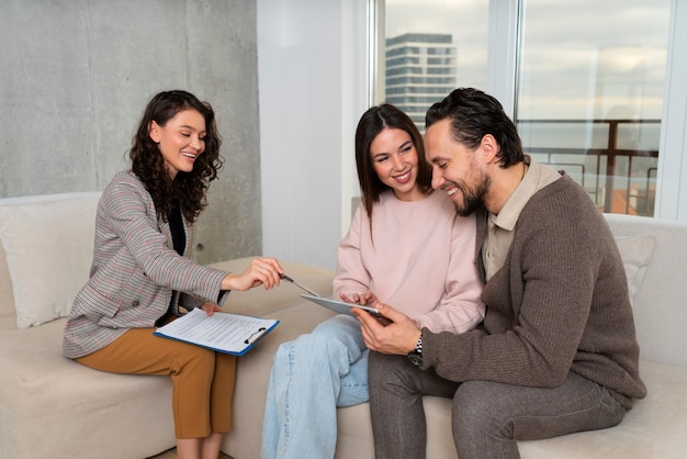 Side view real estate agent presenting house