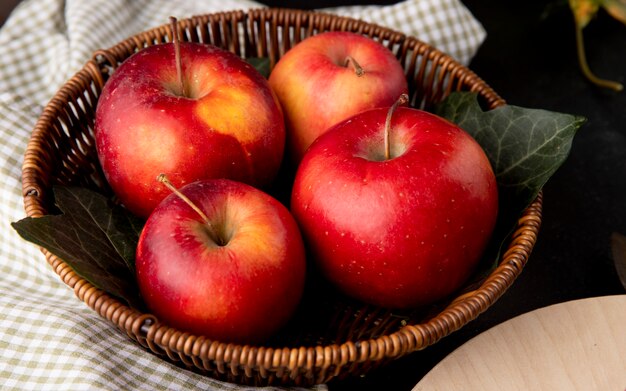 Side view red apples in a basket