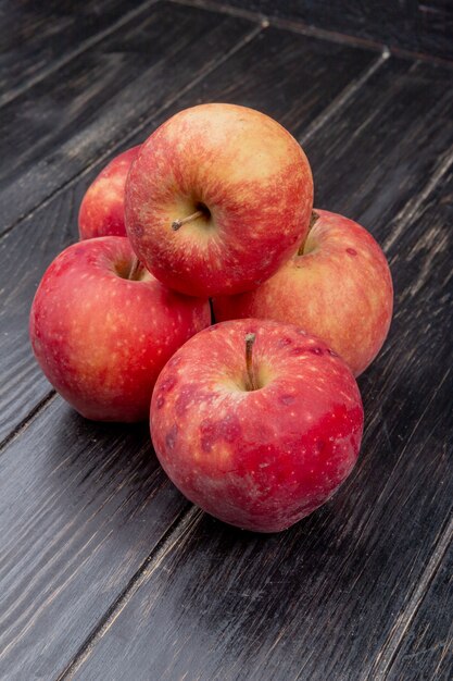 side view of red apples on wooden