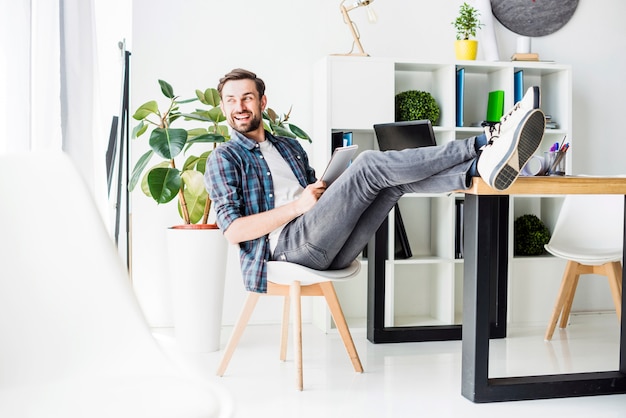 Side view of a relaxed happy businessman sitting in office