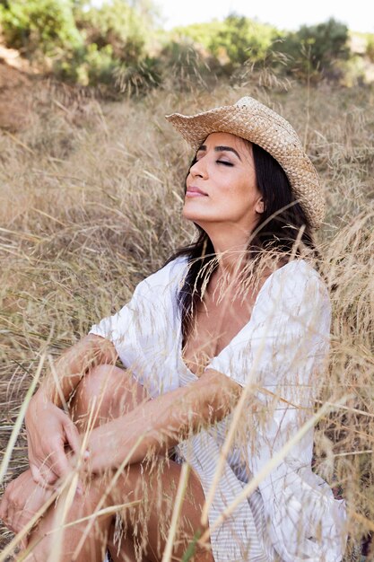 Side view of relaxed woman posing outside in nature