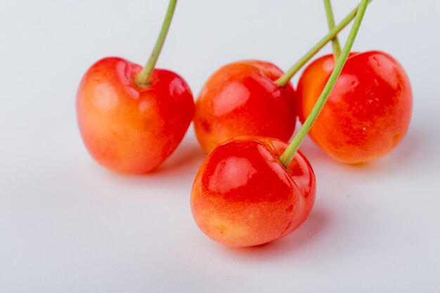 Side view of ripe rainier cherries isolated on white