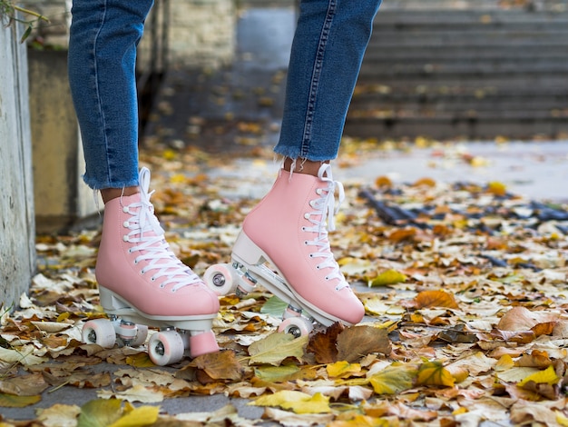 Free photo side view of roller skates on leaves