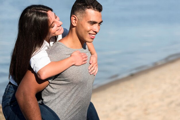 Side view of romantic couple at the beach with copy space