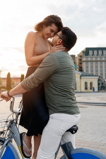 Side view romantic couple on bicycle