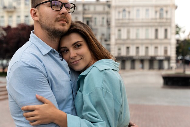 Side view romantic couple hugging outdoors