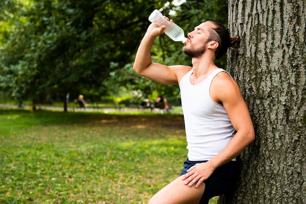 Side view of runner drinking water