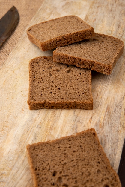 Side view of rye bread slices on wooden surface