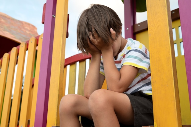 Side view  sad boy in park