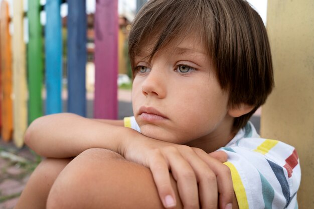 Side view sad boy in park