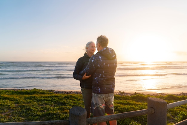 Free photo side view senior couple on beach