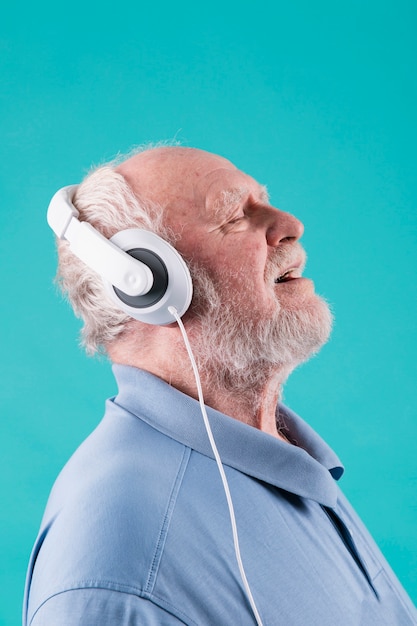 Side view senior enjoying music