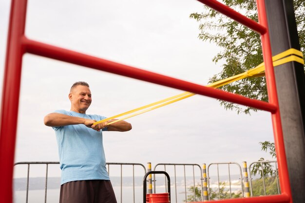 Side view of senior man working out outside