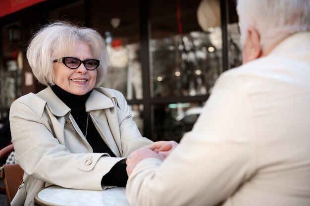 Side view senior people holding hands