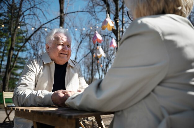 Side view senior people holding hands