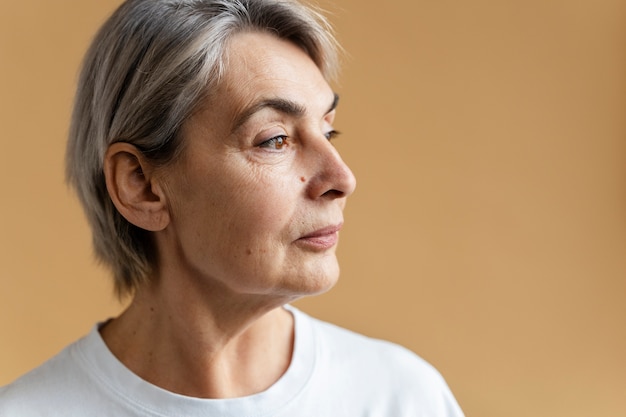 Side view senior woman with moles on face