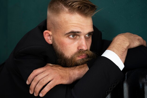 Side view sensitive man posing in studio