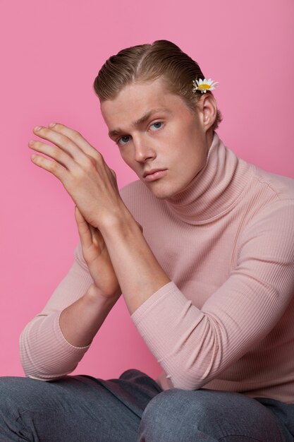 Side view sensitive man posing with flower