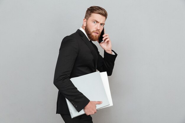 Side view of a Serious bearded man in suit