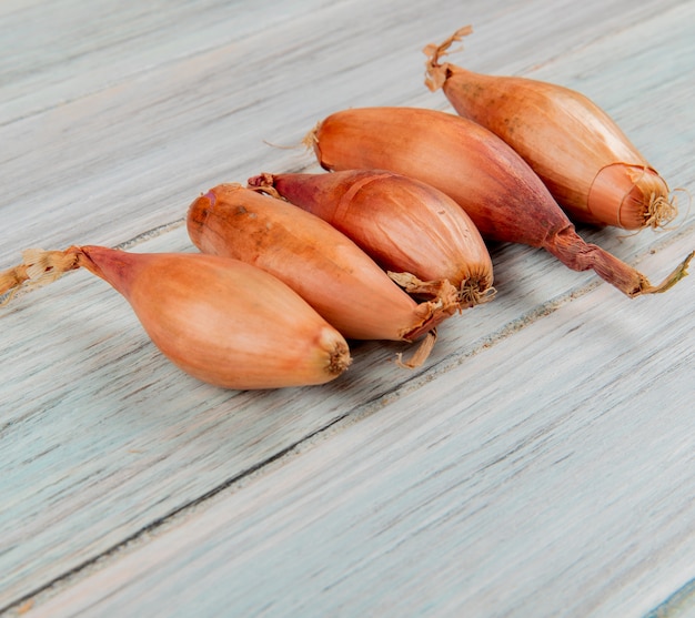 Side view of shallots on wooden background