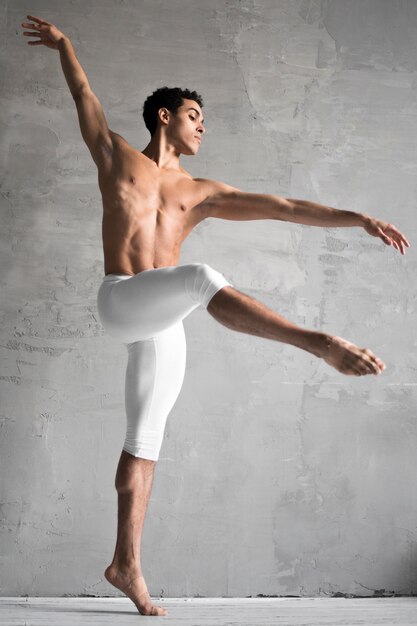 Side view of shirtless male ballet dancer