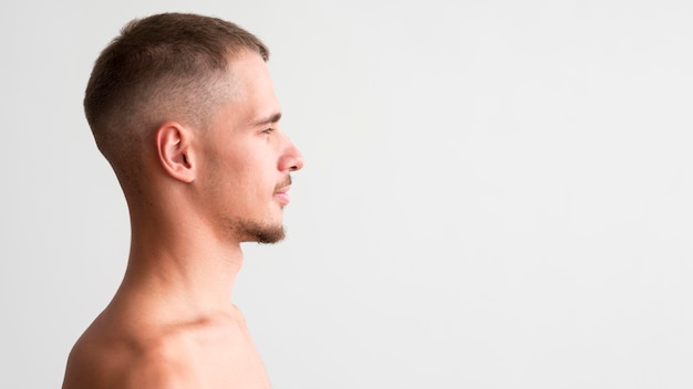 Side view of shirtless man with copy space
