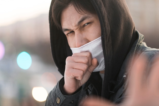 Free photo side view of sick man coughing