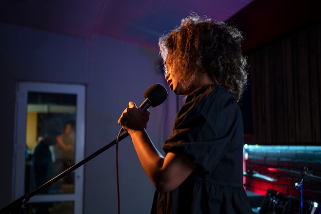 Side view singer working in a studio