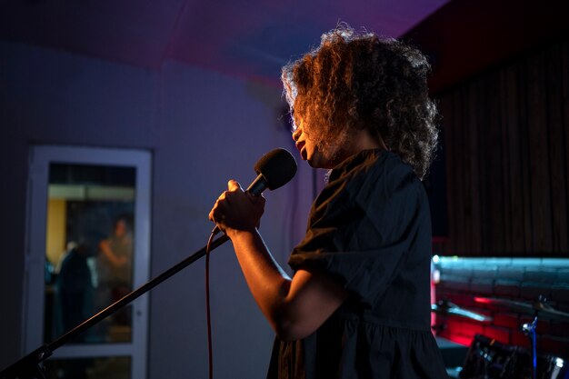 Side view singer working in a studio