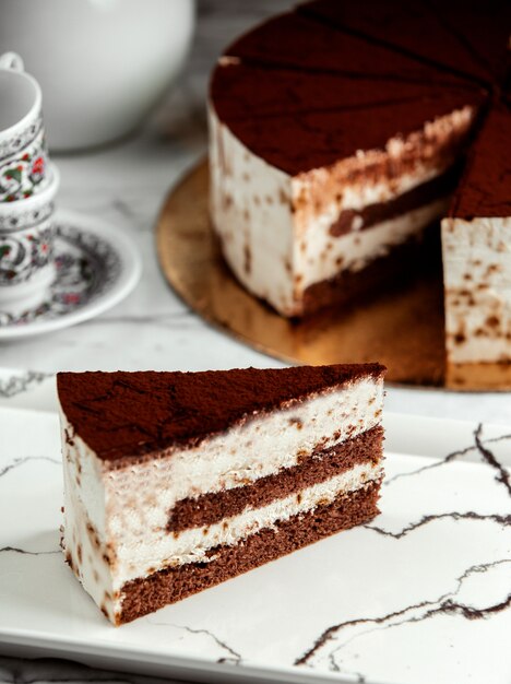 Side view of slice of tiramisu cake on plate