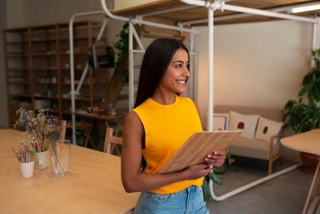 Free photo side view smiley arab woman posing indoors