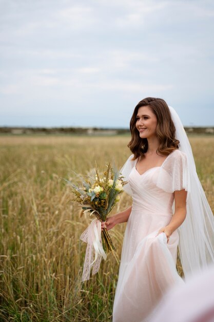 Side view smiley bride holding flowers