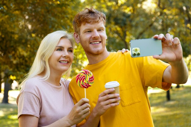 Side view smiley couple taking selfie