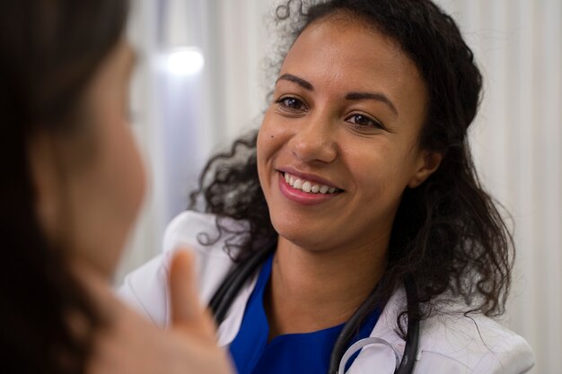 Side view smiley doctor checking patient