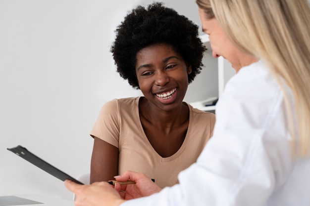 Side view smiley doctor and patient