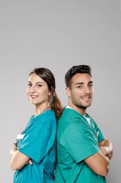 Side view of smiley doctors posing