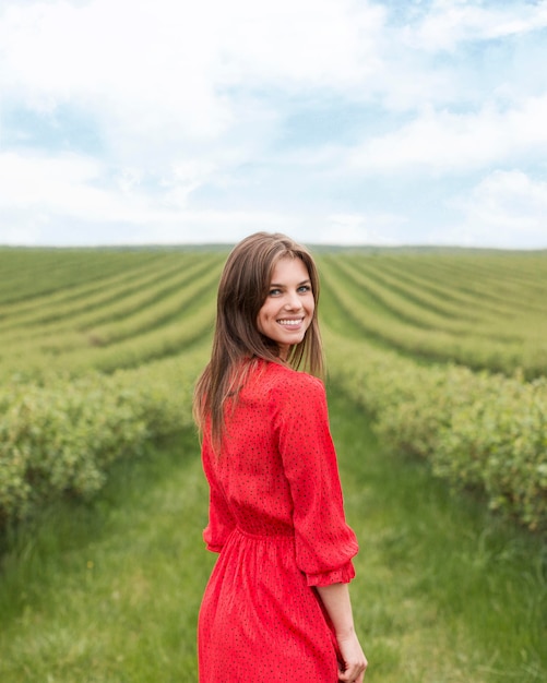 Side view smiley female walking on field