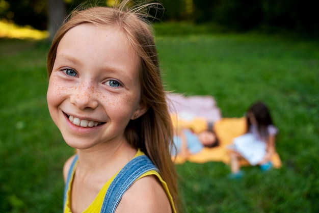 Free photo side view smiley girl outside