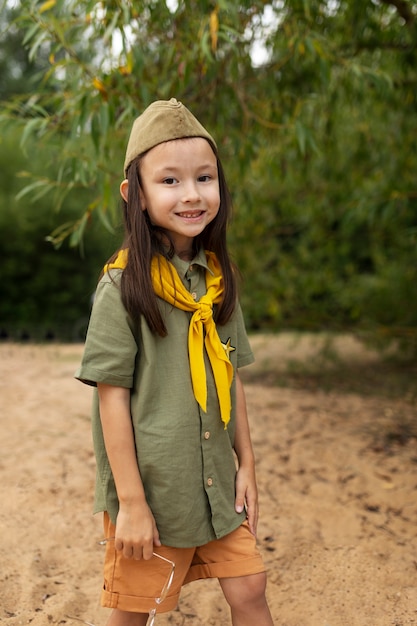 Free photo side view smiley girl scout