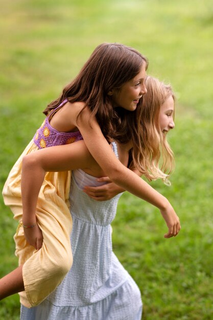 Side view smiley girls in nature