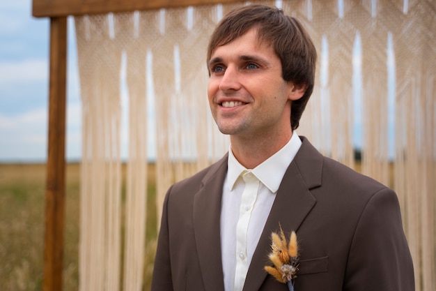 Side view smiley groom outdoors