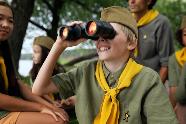 Side view smiley kid with binoculars