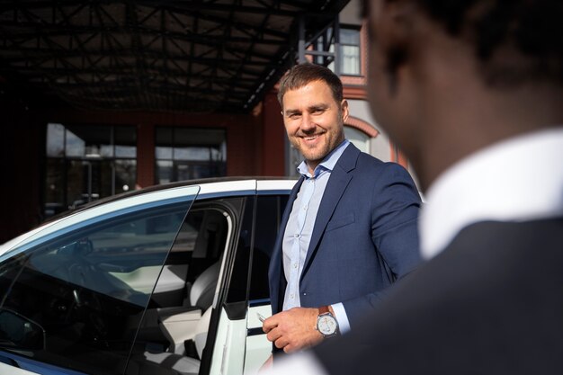 Side view smiley man getting in car