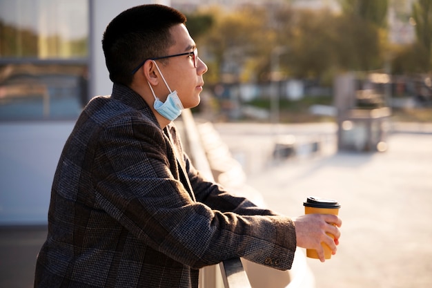 Side view smiley man holding coffee cup