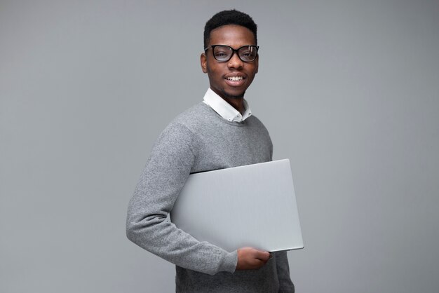 Side view smiley man holding laptop