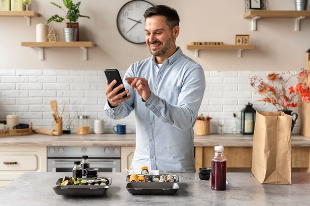 Side view smiley man holding smartphone