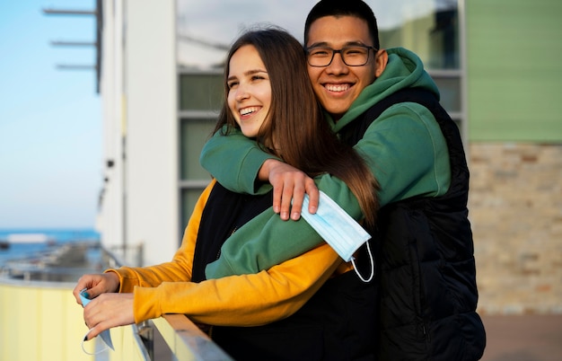 Side view smiley man hugging girlfriend